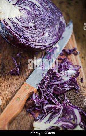 Red cabbage sliced on farmhouse kitchen table. Clean eating concept. Stock Photo