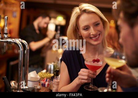 Couple Meeting For Evening Drinks In Cocktail Bar Stock Photo