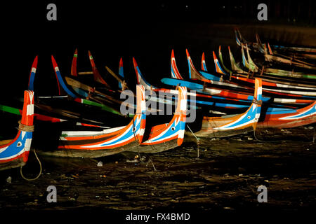 Colourful prows of rowing boats in darkness on Taungthaman Lake at U Bein's Bridge, Amarapura, Mandalay, Myanmar (Burma) Stock Photo