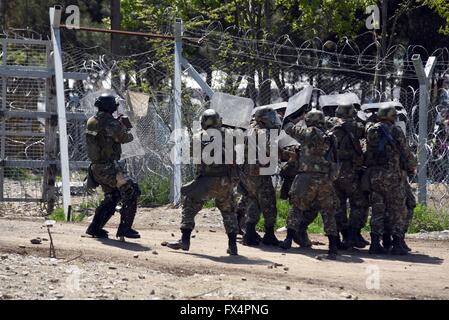 (160411) -- GEVGELIJA, April 11, 2016 (Xinhua) -- Macedonian policemen react during clashes with migrants trying to illegally cross the Macedonian-Greek border near Gevgelija, Macedonia, April 10, 2016. A total of 23 Macedonian security officers are injured on Sunday in the clashes with the migrants trying to enter Macedonian territory from Greece, Macedonian Ministry of Interior reported. (Xinhua) Stock Photo
