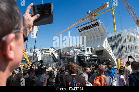 Munich, Germany. 11th Apr, 2016. Trade fair visitors look at construction equipment from Liebherr at the opening of Bauma, the world's largest construction fair, in Munich, Germany, 11 April 2016. Photo: PETER KNEFFEL/dpa/Alamy Live News Stock Photo
