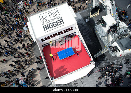 Table Tennis players Timo Boll (l) from Germany and Werner Schlager from Austria playing in the dump truck T264 of manufacturer Liebherr at the construction fair Bauma in Munich, Germany, 12 April 2016. More than 3,400 exhibitors from roughly 60 countries present their innovations from 11 April until 17 April 2016. PHOTO: SVEN HOPPE/dpa Stock Photo