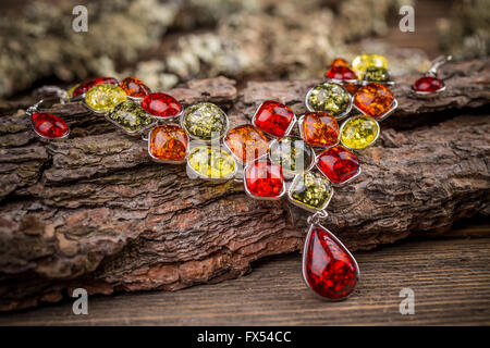Colorful stones necklace on wooden surface Stock Photo