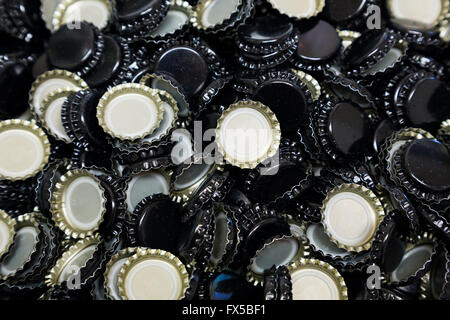 Bottle caps in a bunch shot in an abstract way during the homebrew bottling process. Stock Photo