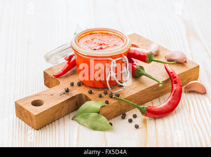 Homemade chili pepper hot sauce with ingredients Stock Photo