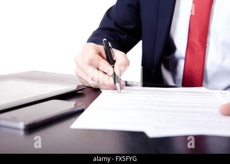 Low angle view of the fingers of a man writing on a document with a fountain pen conceptual of communication, correspondence, business agreement, legal contract or creativity Stock Photo