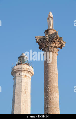 The lighthouse of Santa Maria di Leuca, Italy, near the high tower crowned by the statue of Saint Mary Stock Photo