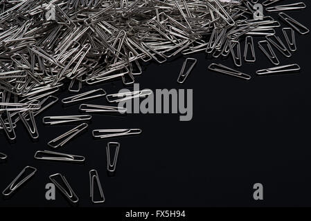 Paper clips on black background Stock Photo