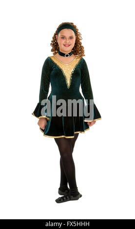 Irish or Celtic Teen Dancer posing with hands by side and feet in fith, wearing a Green Velvet  Recital Costume shot against a white background. Stock Photo