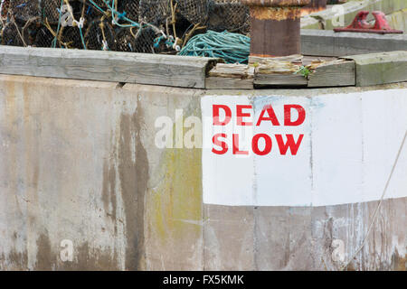 Dead Slow speed warning at harbour entrance Stock Photo