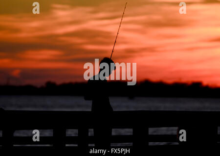 Fishing at sunset Stock Photo