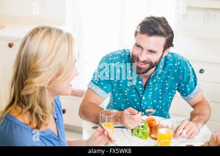 Young couple sitting at dining table talking Stock Photo