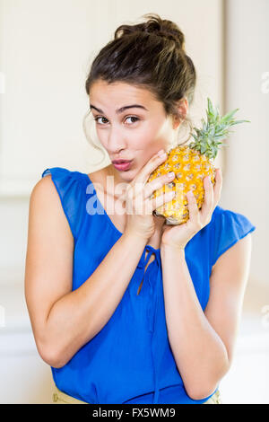 Portrait of young woman holding pineapple Stock Photo