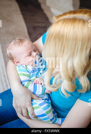 Mother keeps a little baby boy in her arms Stock Photo