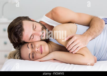 Young couple sleeping on bed Stock Photo