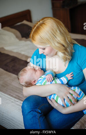 Mother keeps a little baby boy in her arms Stock Photo