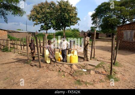 Gathering water from a well in Uganda, Africa Stock Photo