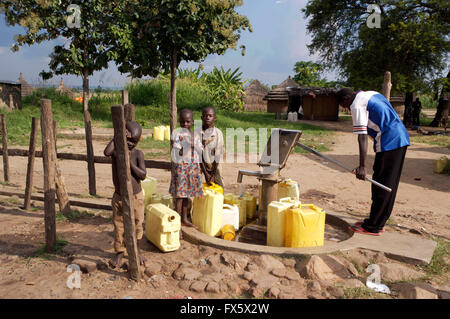 Gathering water from a well in Uganda, Africa Stock Photo
