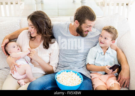 Family having fun while watching television Stock Photo