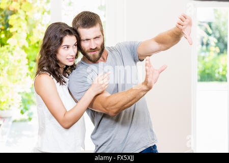Couple framing a picture with hands Stock Photo