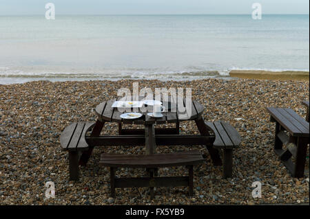 Breakfast leftovers on beach picnic table, Hove, Sussex, UK Stock Photo
