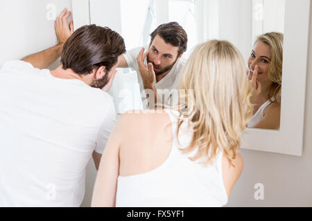 Young couple applying cream on the face Stock Photo