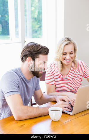 Happy young couple using laptop Stock Photo