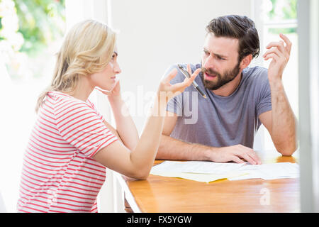 Worried young couple discussing on bills Stock Photo