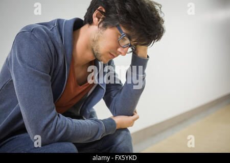 Thoughtful student sitting on chair Stock Photo