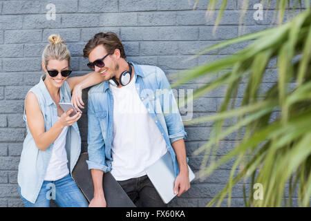 Young couple using mobile phone Stock Photo