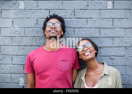 Young couple leaning against wall Stock Photo