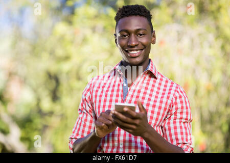 Happy man posing and holding his smartphone Stock Photo