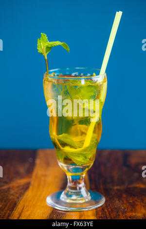 Mojito with mint in a traditional mixed drink glass served with a straw at a Mexican restaurant bar. Stock Photo