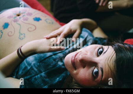 Pregnant Caucasian woman with drawings on belly Stock Photo