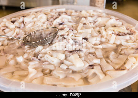 Sliced fresh squids caught by local fishermen are for sale and ready to be cooked at the local market in Turkey Stock Photo