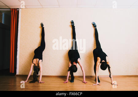 Caucasian dancers stretching in studio Stock Photo