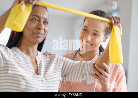 Patient having physical therapy in living room Stock Photo