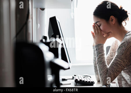 Hispanic woman using computer Stock Photo