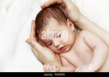 Newborn baby in mother's hands Stock Photo