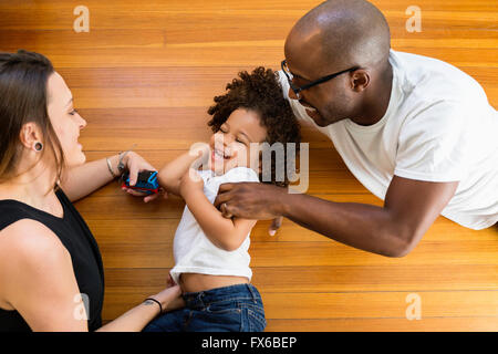 Family playing on floor Stock Photo