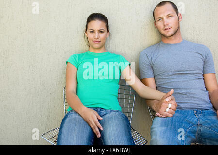 Caucasian couple holding hands outdoors Stock Photo