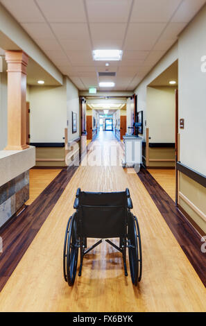 Empty wheelchair in assisted living facility Stock Photo