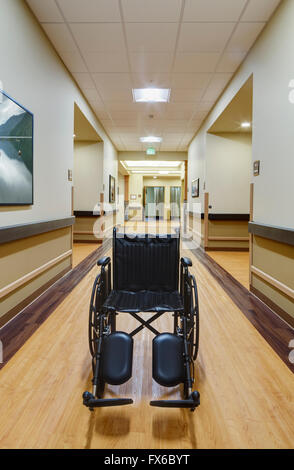 Empty wheelchair in assisted living facility Stock Photo