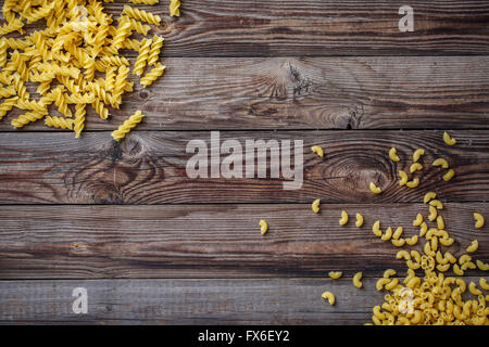 Mixed dried pasta selection on wooden background. Stock Photo