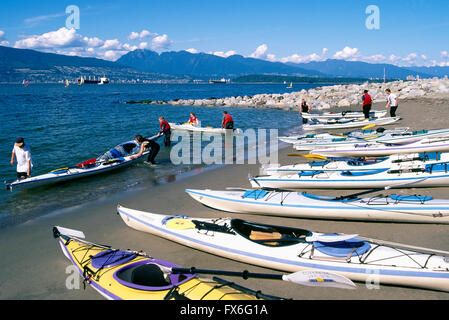 Vancouver, BC, British Columbia, Canada - Kayakers preparing Kayaks for Kayak Trip at Jericho Beach along English Bay Stock Photo