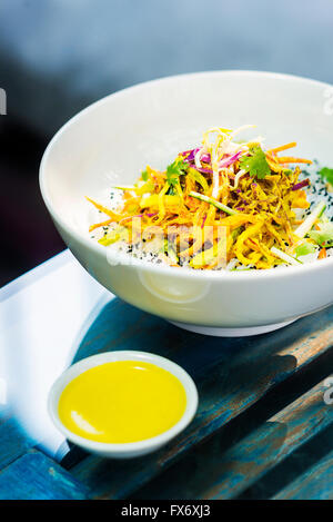 curry sauce vegetable salad with noodles and sesame modern asian fusion dish Stock Photo