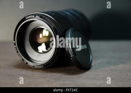 Very popular Canon EF 50mm f/1.8 II lens with extension tube on black background Stock Photo