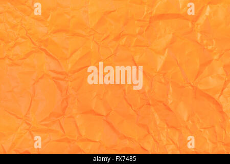 background from orange colour wrapping paper close up Stock Photo