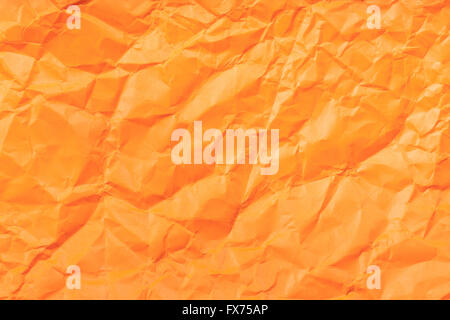 background from orange colour crumpled paper Stock Photo