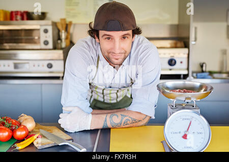 Food entrepeneur with some freshly minced red meat in kitchen Stock Photo